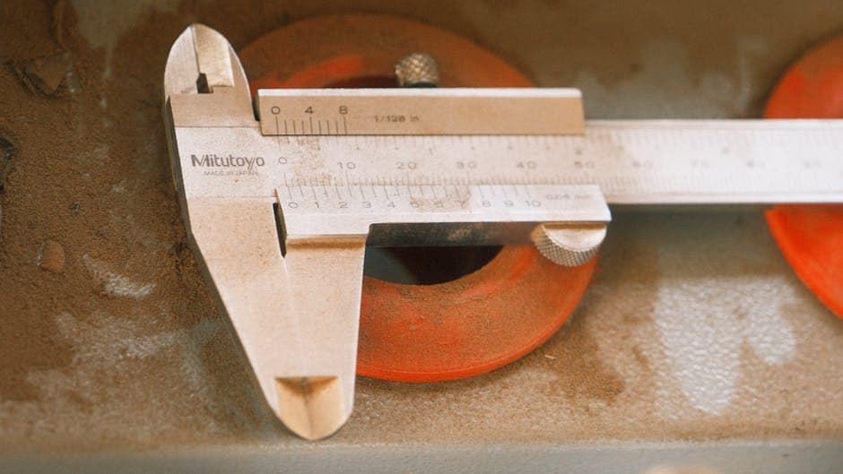 Precision measurement caliper on an industrial surface representing manufacturing performance metrics