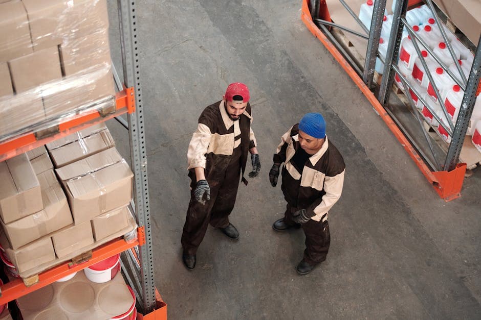 Two warehouse managers reviewing logistics and inventory management for supply chain coordination