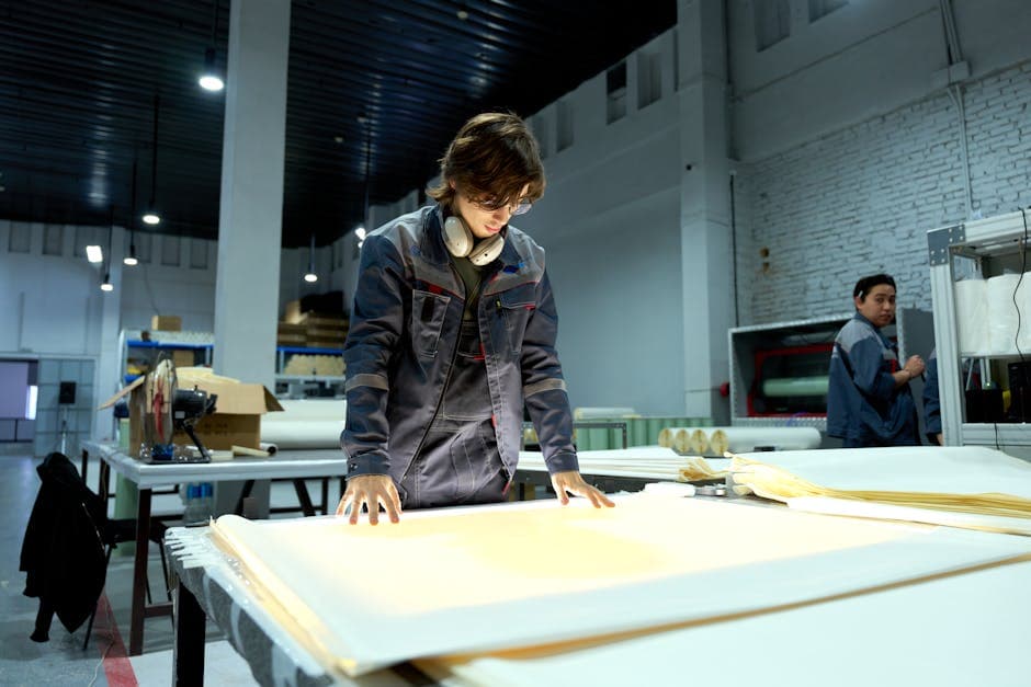 Industrial worker inspecting materials on a factory floor as part of a quality control process