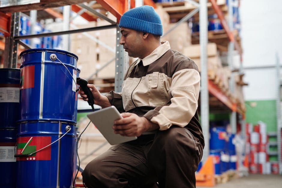 Warehouse employee scanning inventory with a tablet to ensure data accuracy for MRP