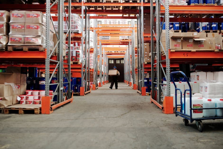 Warehouse workers processing shipments on a fulfillment line in a manufacturing facility