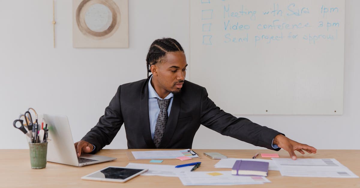 Manufacturing operations manager reviewing scheduling software pricing comparison on a laptop
