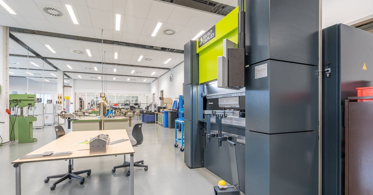 Manufacturing team reviewing a smart factory implementation roadmap with connected equipment in the background