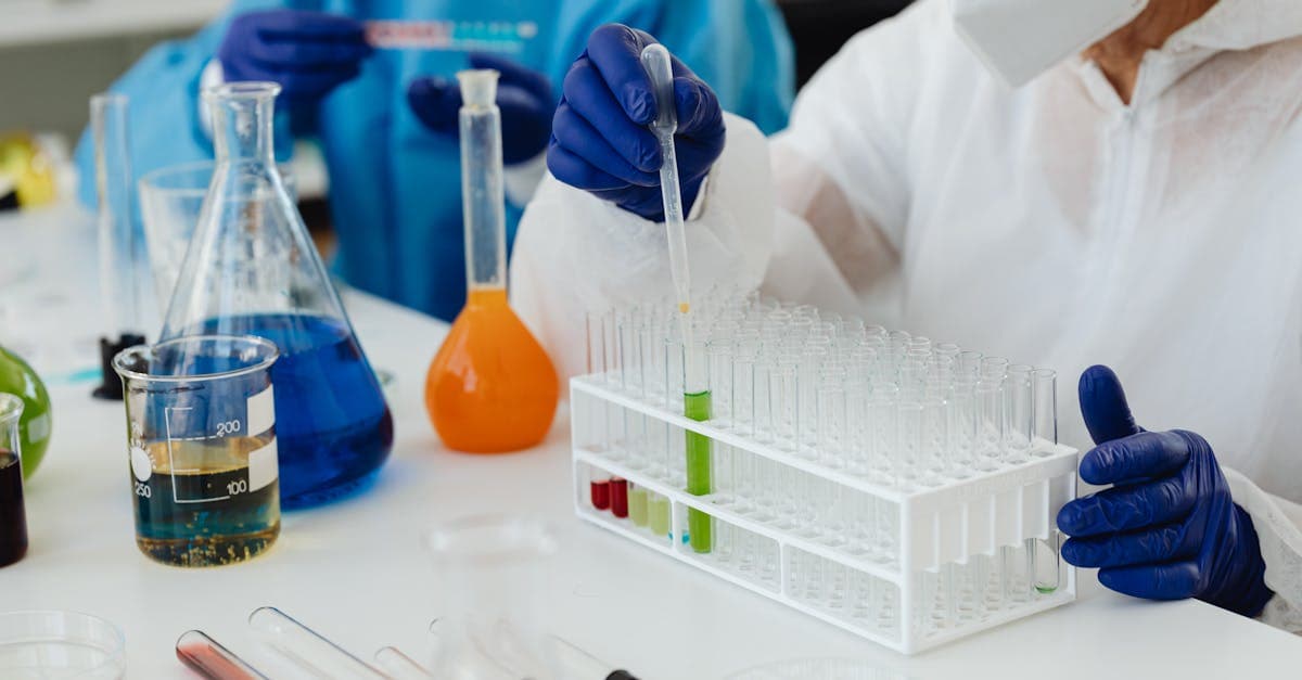 Quality engineer analyzing SPC control charts on a monitor next to a manufacturing production line