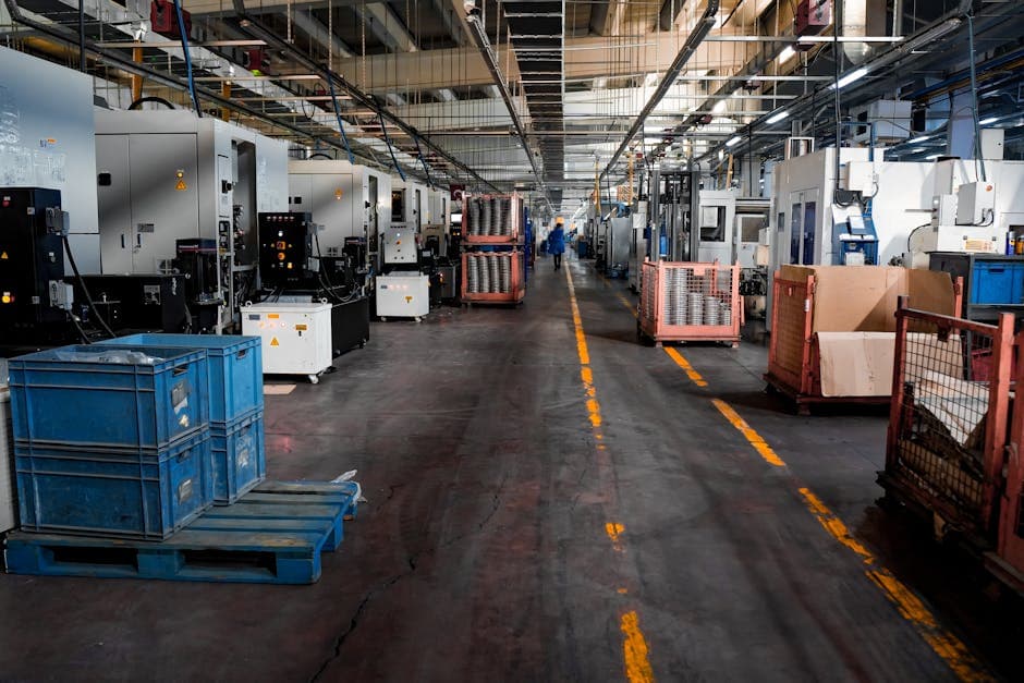 Industrial factory floor with machinery and crates illustrating supply chain operations