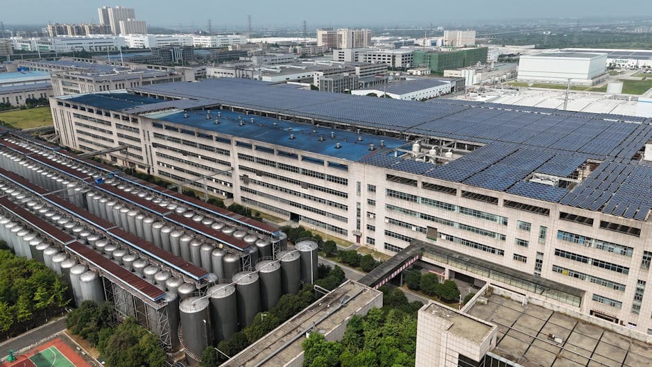 Industrial facility with solar panel rooftop representing sustainable manufacturing practices